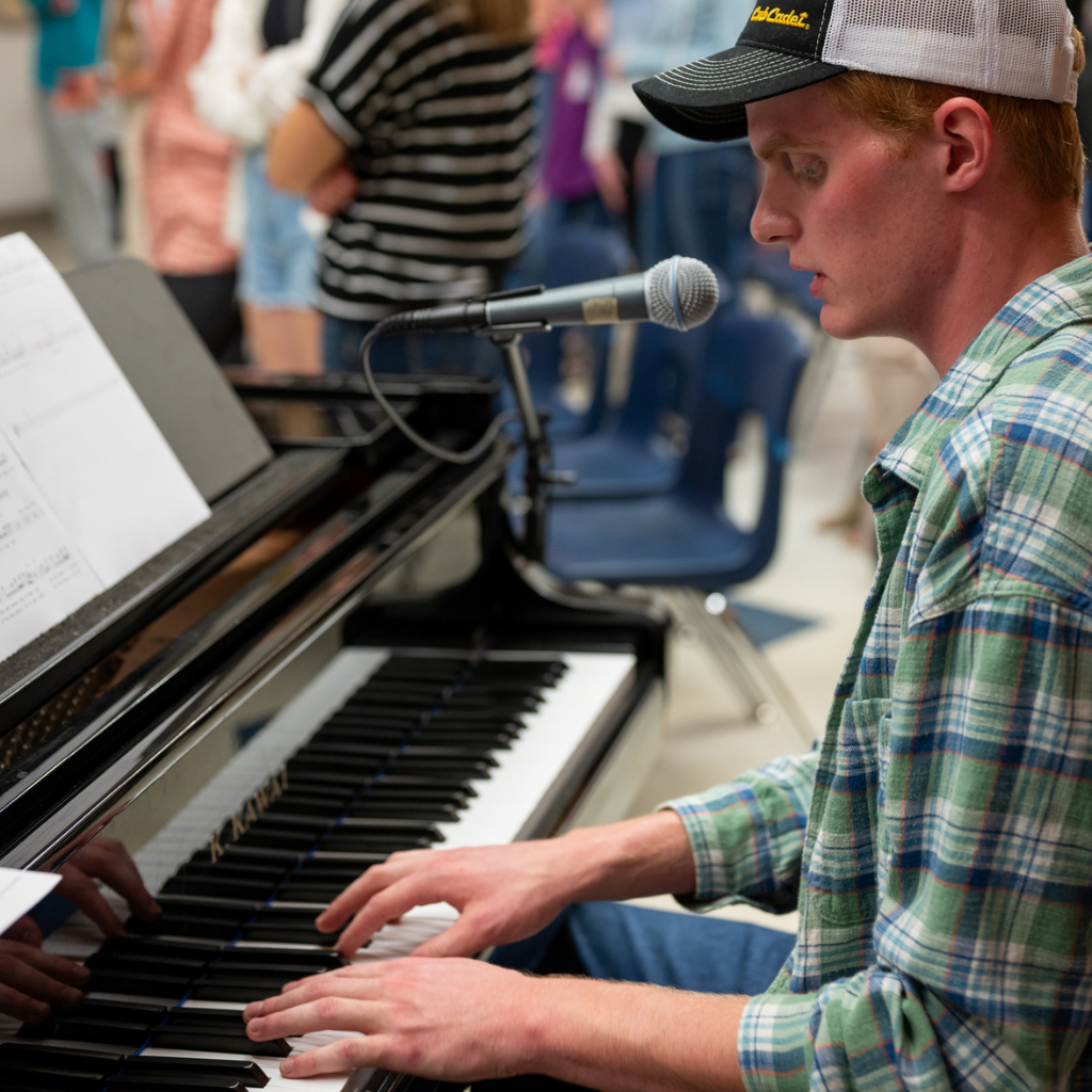 London Christian High Grade 12 Student playing piano at a student-lead worship night.