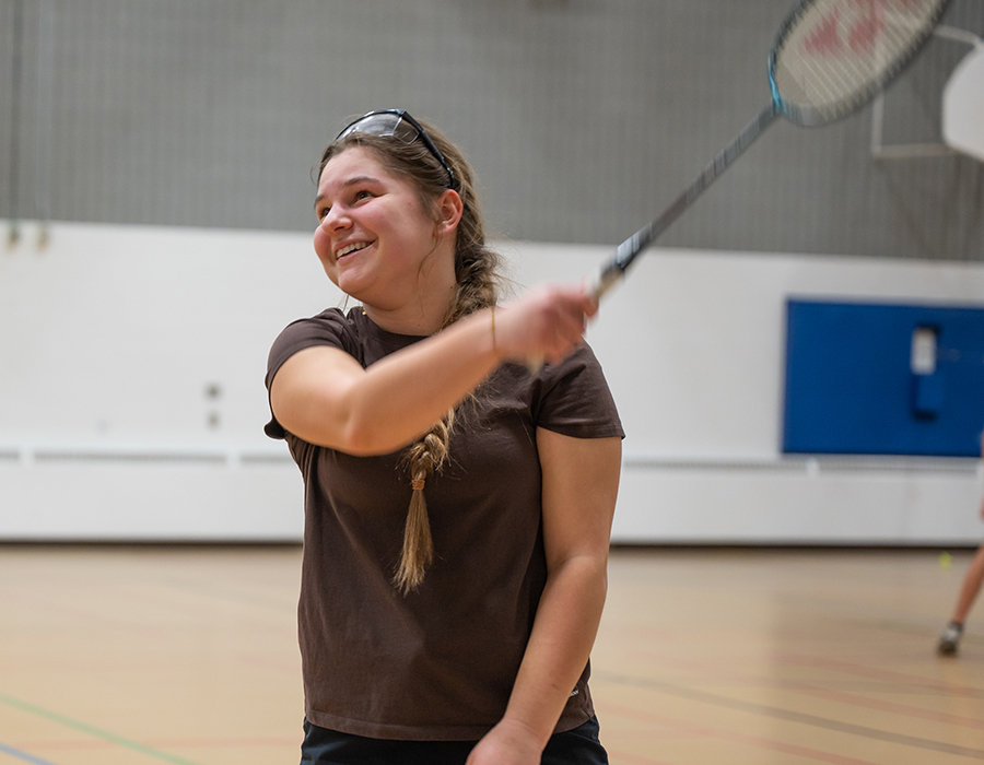 female student hitting badminton