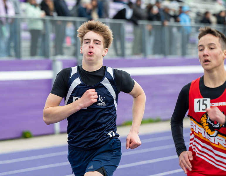 male student running track