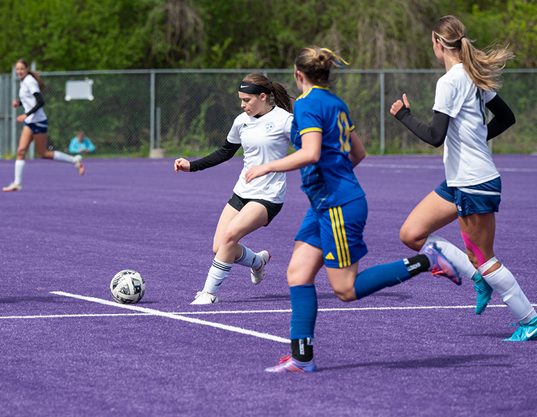 girls team playing soccer