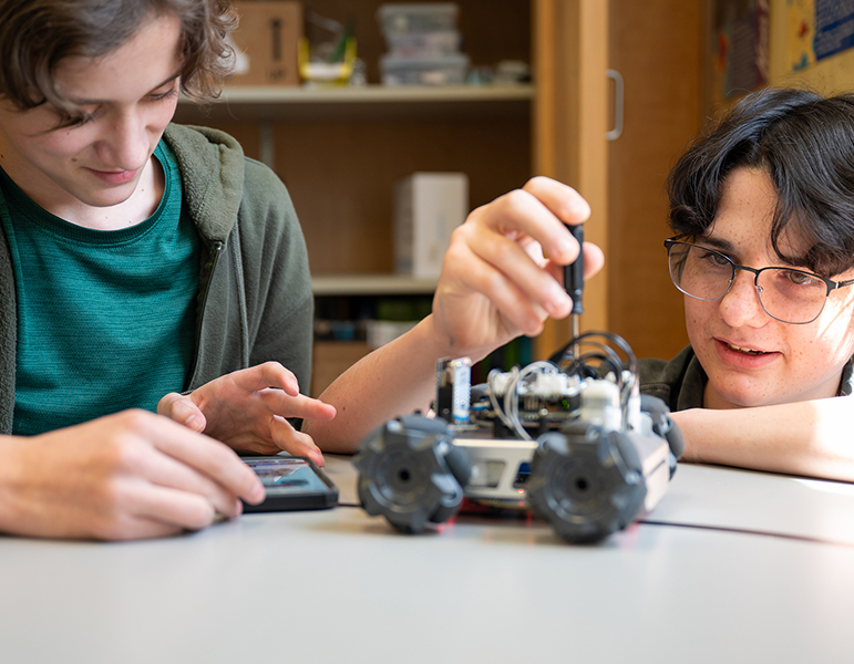 two students working on robotics