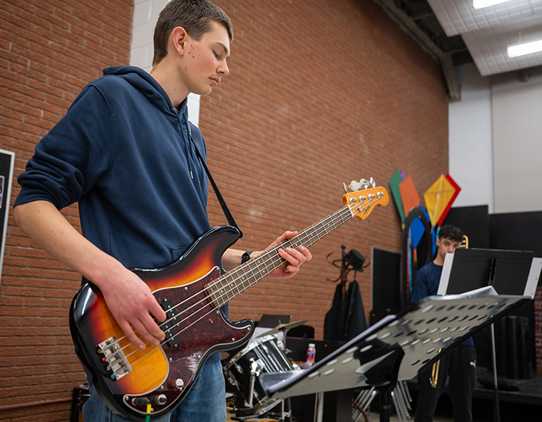student playing electric guitar